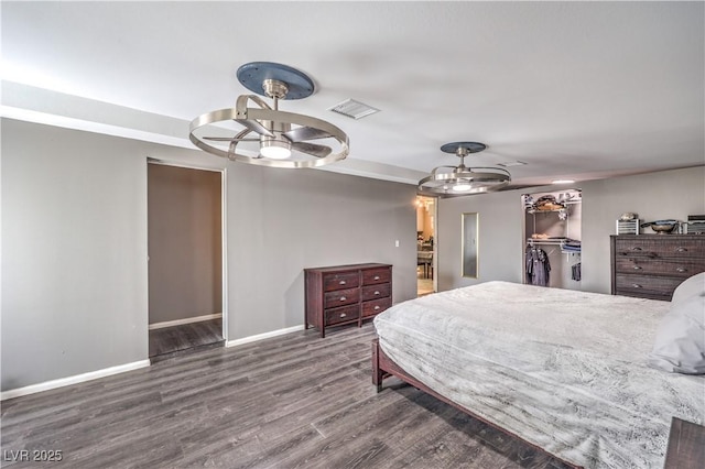 bedroom featuring dark hardwood / wood-style flooring, a closet, and a spacious closet