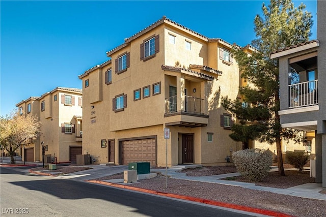 view of property featuring a garage and central air condition unit