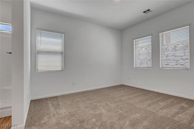 unfurnished room featuring light colored carpet