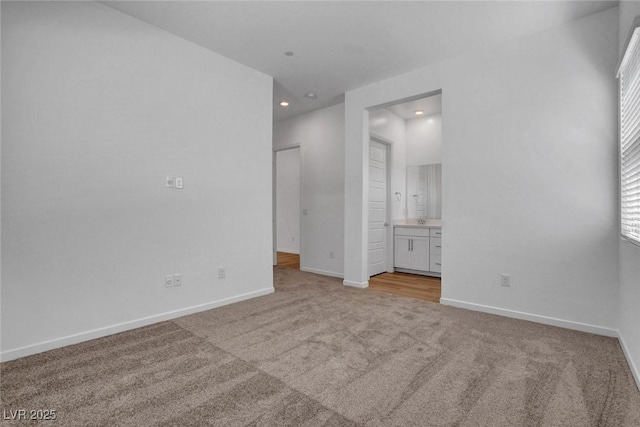 unfurnished room with light carpet