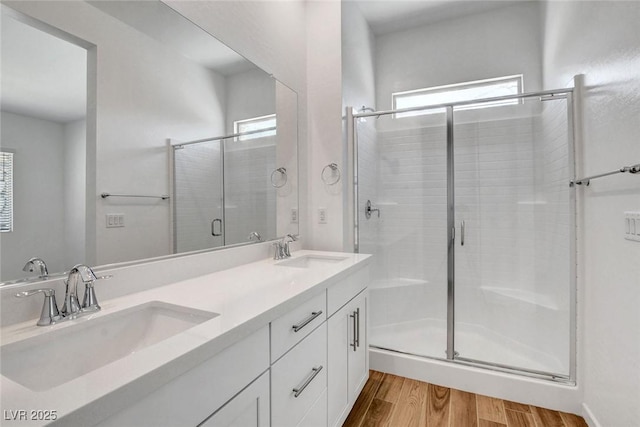 bathroom featuring an enclosed shower, hardwood / wood-style floors, and vanity