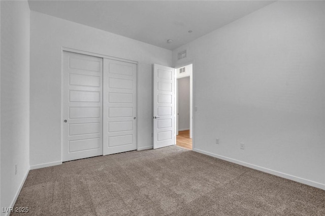 unfurnished bedroom with a closet and carpet