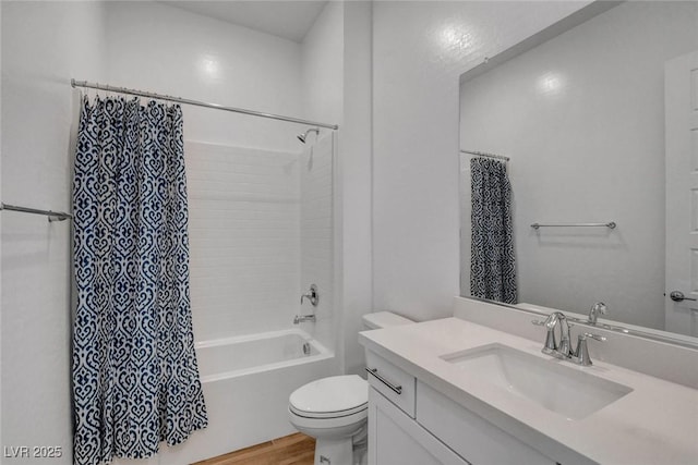 full bathroom with hardwood / wood-style flooring, shower / bath combo, vanity, and toilet