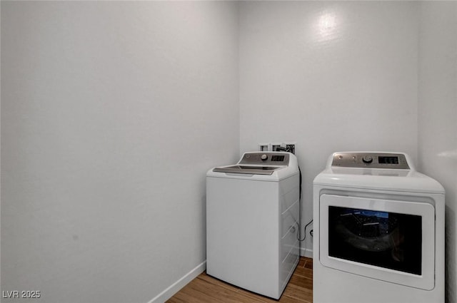 laundry area featuring hardwood / wood-style flooring and washer and dryer