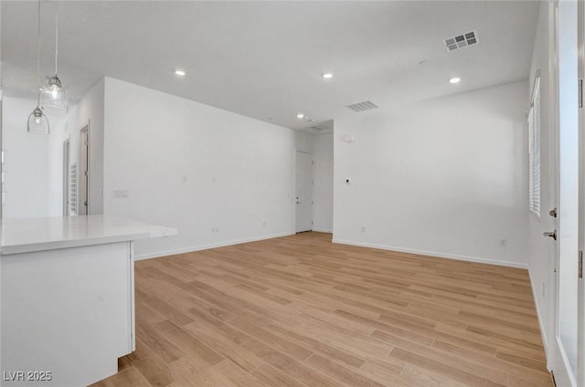 unfurnished living room with light hardwood / wood-style flooring