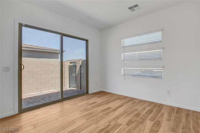 spare room with light wood-type flooring