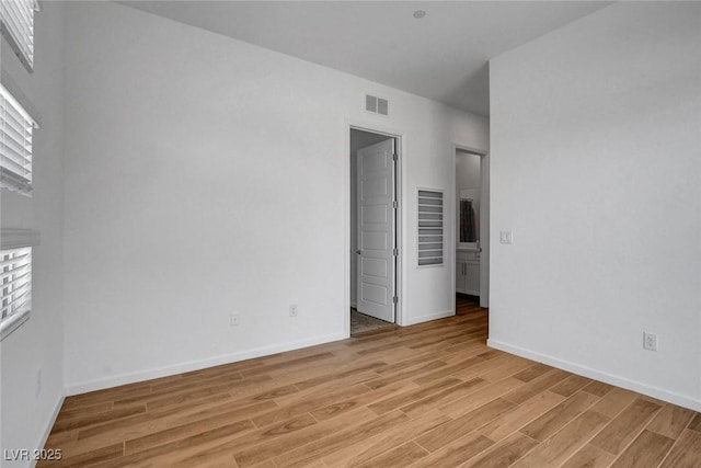 spare room featuring light wood-type flooring