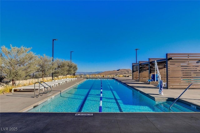 view of pool featuring a patio and a mountain view