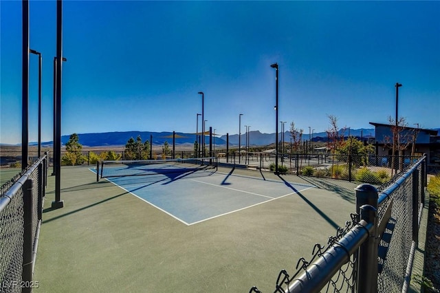 view of tennis court with a mountain view