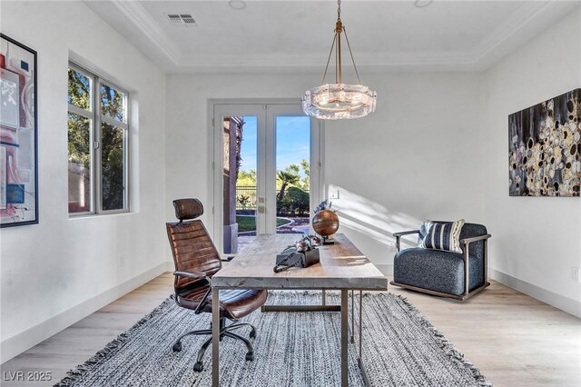 office area with ornamental molding, plenty of natural light, and light hardwood / wood-style flooring