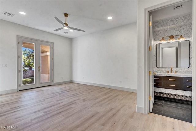 interior space with french doors, sink, ceiling fan, and light hardwood / wood-style flooring