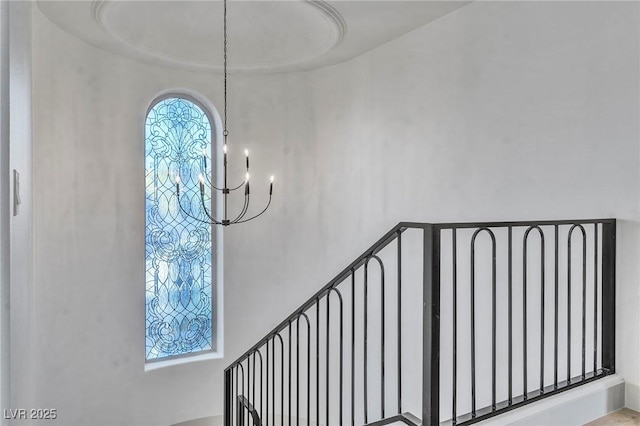 stairway with an inviting chandelier