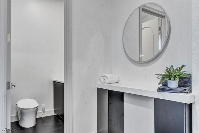 bathroom with tile patterned flooring, vanity, and toilet