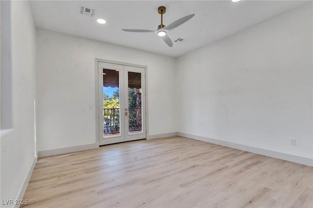 empty room with baseboards, french doors, visible vents, and light wood-style floors