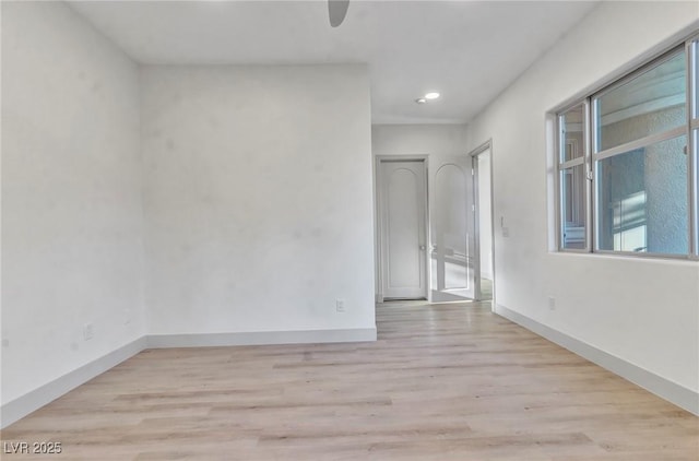 unfurnished room with light wood-style floors, recessed lighting, and baseboards