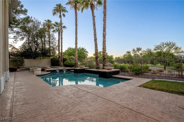 pool at dusk with a patio