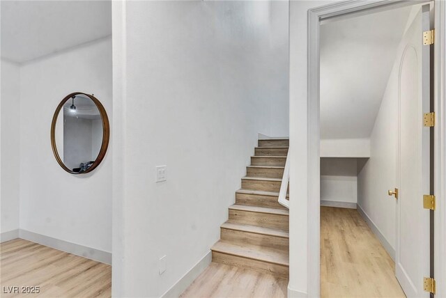 stairs featuring hardwood / wood-style floors