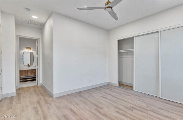 unfurnished bedroom featuring light wood finished floors, a closet, visible vents, and baseboards