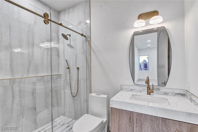 full bath featuring toilet, a marble finish shower, and vanity