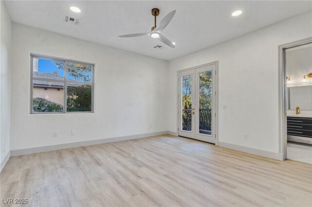 empty room featuring ceiling fan, light hardwood / wood-style floors, and french doors