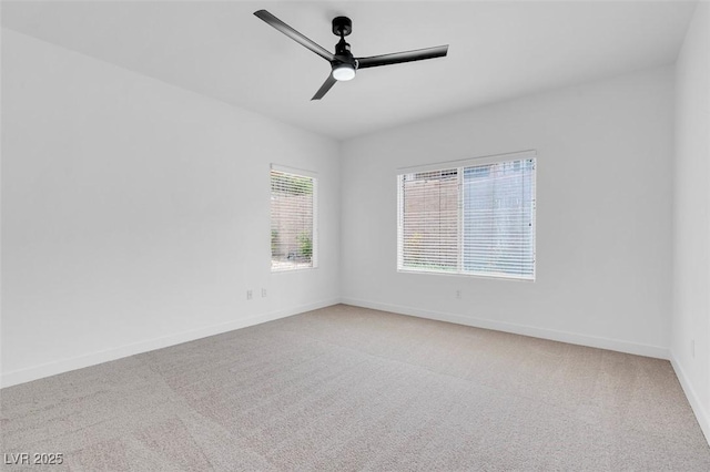 empty room featuring ceiling fan and carpet