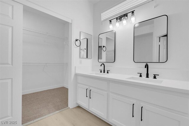 bathroom with vanity and hardwood / wood-style floors