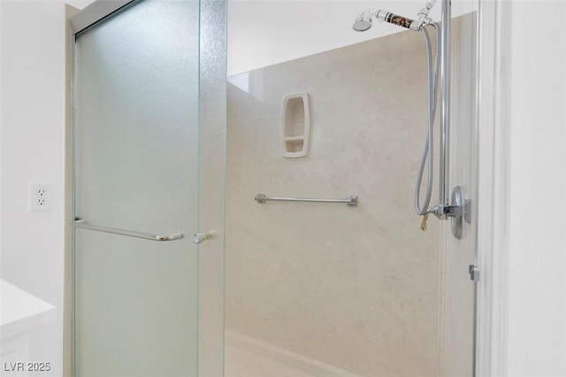 bathroom featuring a shower with door