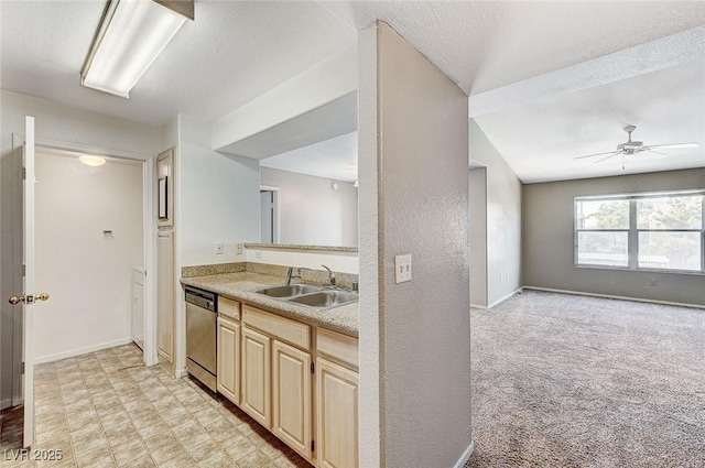 kitchen with sink, dishwasher, ceiling fan, a textured ceiling, and light colored carpet