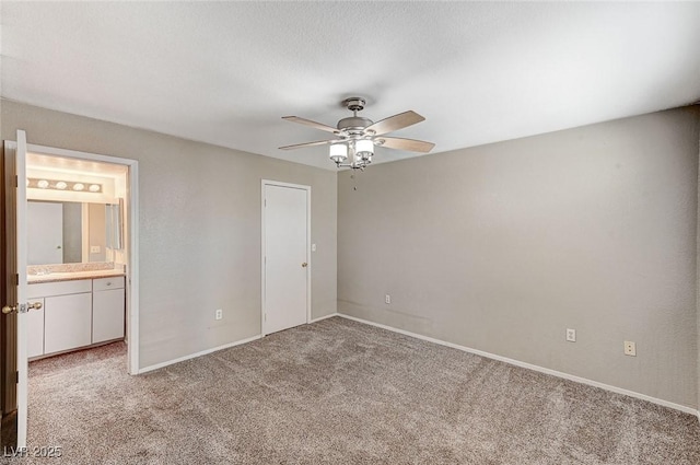 unfurnished bedroom with light colored carpet, ceiling fan, and ensuite bathroom