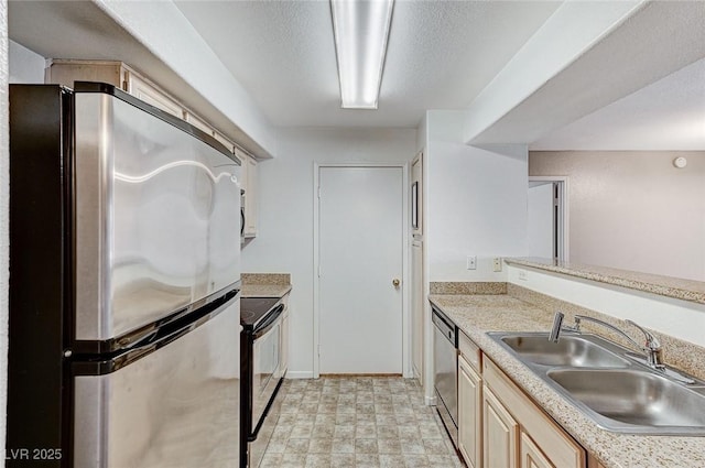 kitchen featuring appliances with stainless steel finishes, sink, and a textured ceiling