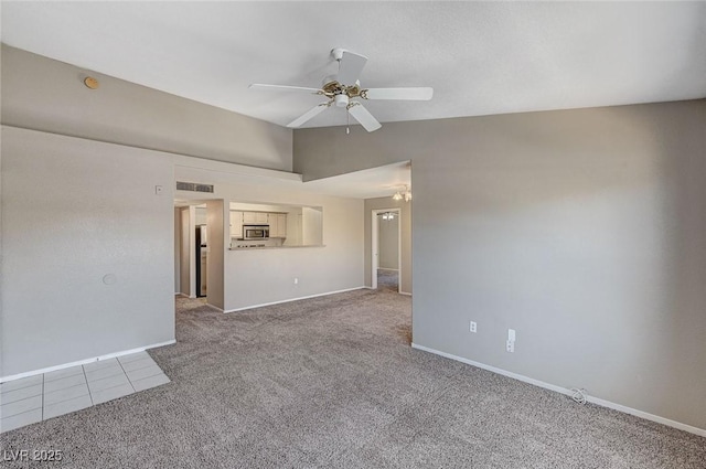 carpeted empty room featuring ceiling fan and lofted ceiling