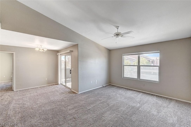 unfurnished room with light carpet, ceiling fan with notable chandelier, and vaulted ceiling