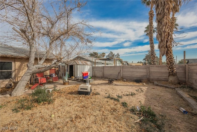 view of yard featuring a patio and a shed