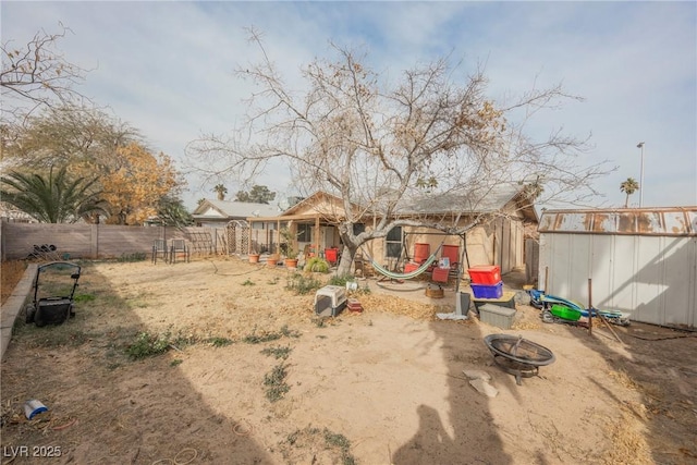 view of yard with a storage shed and a fire pit