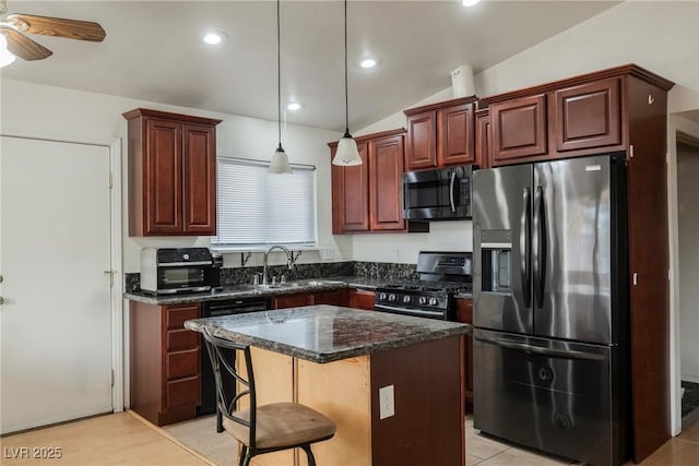 kitchen featuring a breakfast bar, sink, decorative light fixtures, a center island, and stainless steel appliances