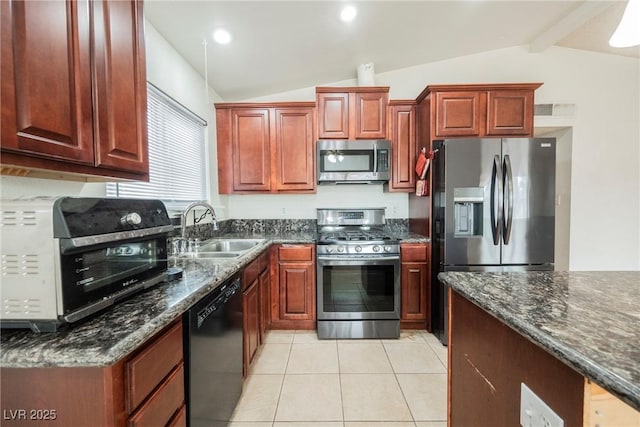 kitchen featuring lofted ceiling with beams, appliances with stainless steel finishes, sink, and dark stone counters