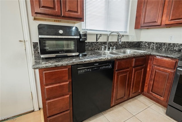 kitchen with sink, light tile patterned floors, dishwasher, dark stone countertops, and stainless steel range oven