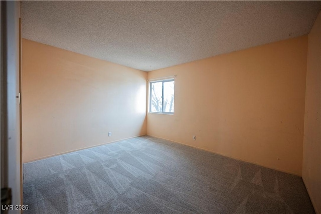 carpeted spare room featuring a textured ceiling