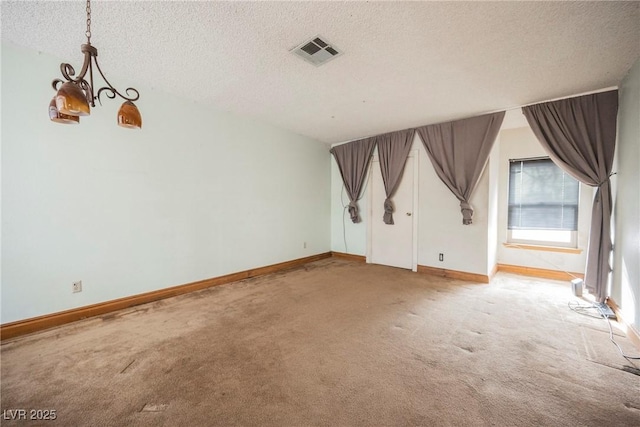 additional living space featuring a chandelier, light colored carpet, and a textured ceiling