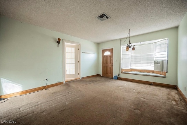 carpeted foyer featuring cooling unit and a textured ceiling