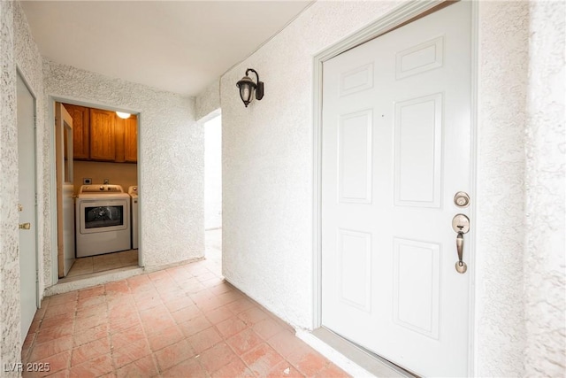 entrance to property featuring washer and dryer