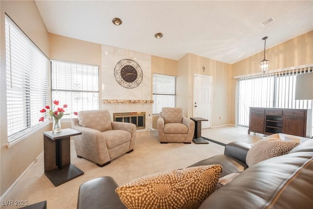 carpeted living room with lofted ceiling and a fireplace