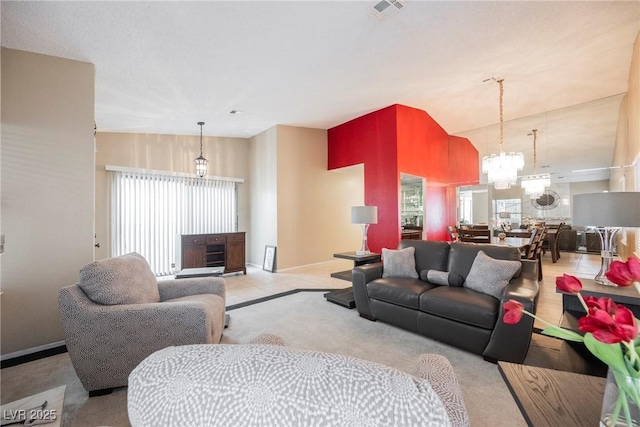 living room with lofted ceiling and a notable chandelier