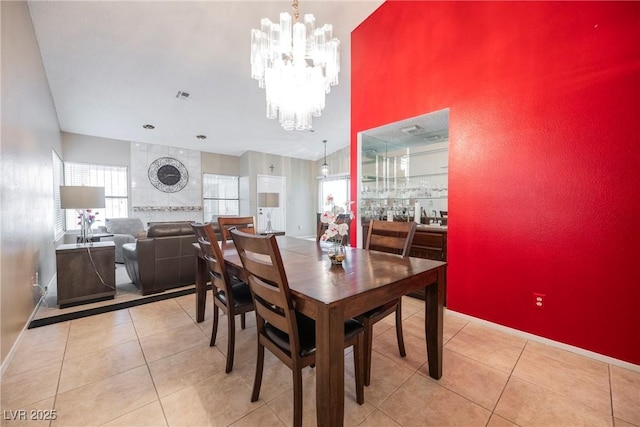 tiled dining room featuring a notable chandelier