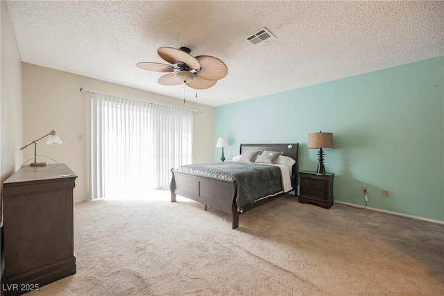 carpeted bedroom with a textured ceiling and ceiling fan