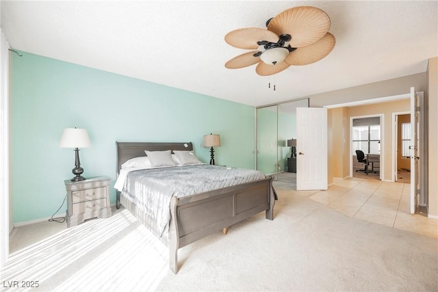 carpeted bedroom with ceiling fan and a closet