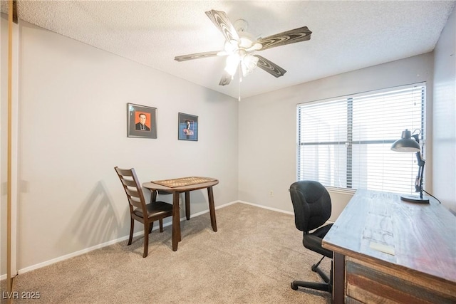 home office featuring light carpet, a textured ceiling, and ceiling fan