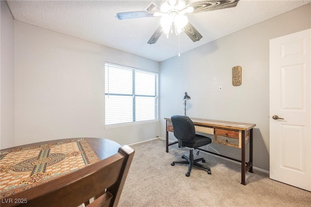 carpeted bedroom featuring ceiling fan and a textured ceiling