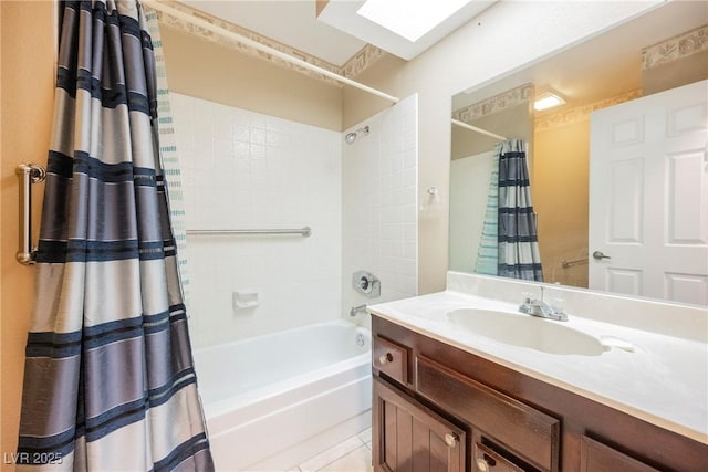 bathroom featuring tile patterned flooring, vanity, shower / bath combo with shower curtain, and a skylight