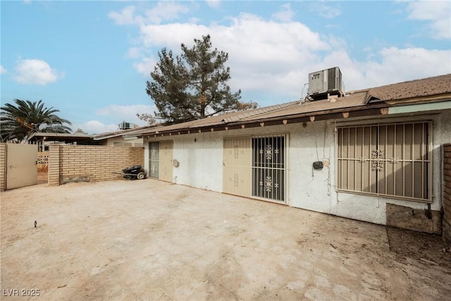 back of property featuring cooling unit and a patio area